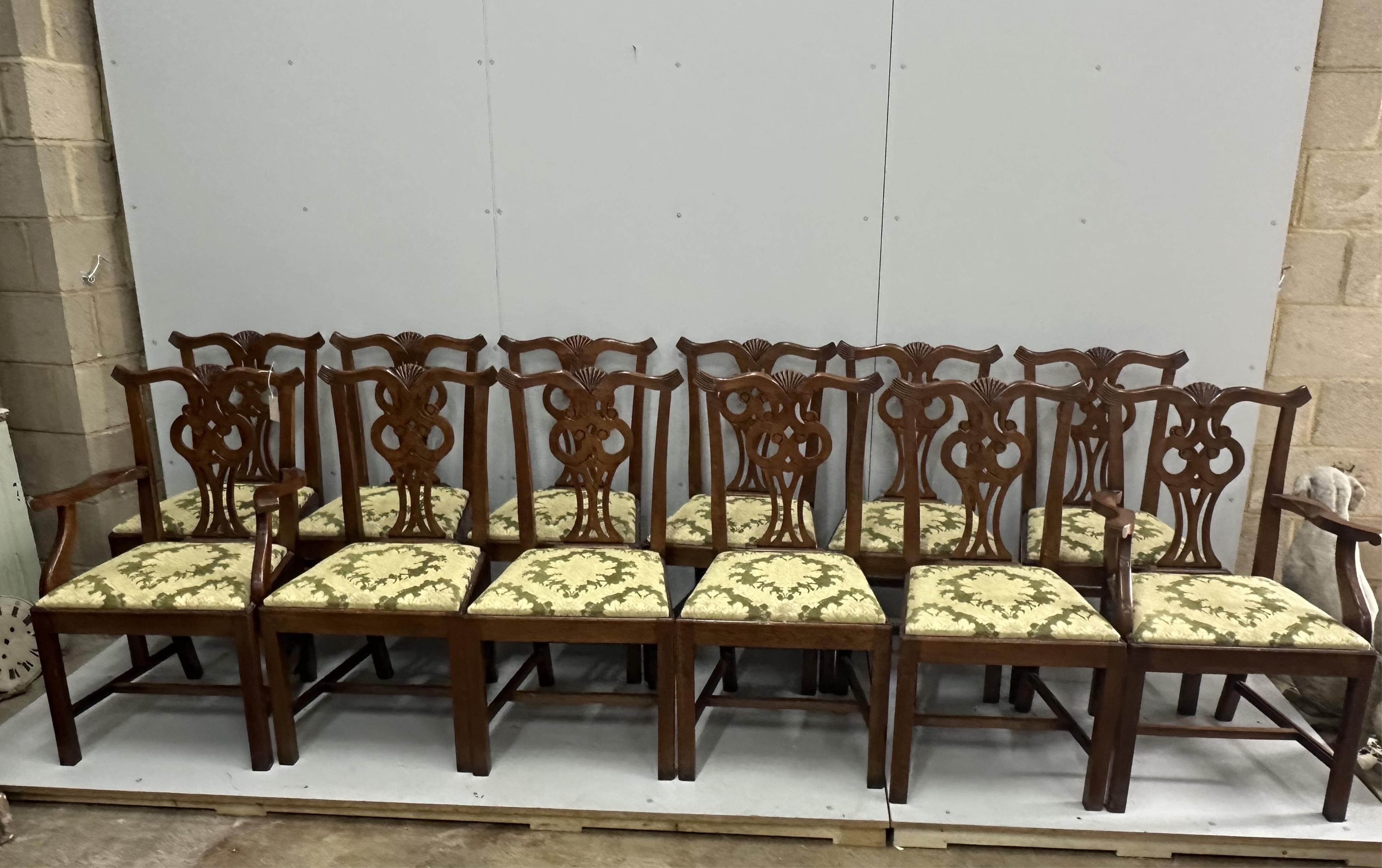 A set of twelve reproduction Chippendale style oak dining chairs, two with arms. Condition - good